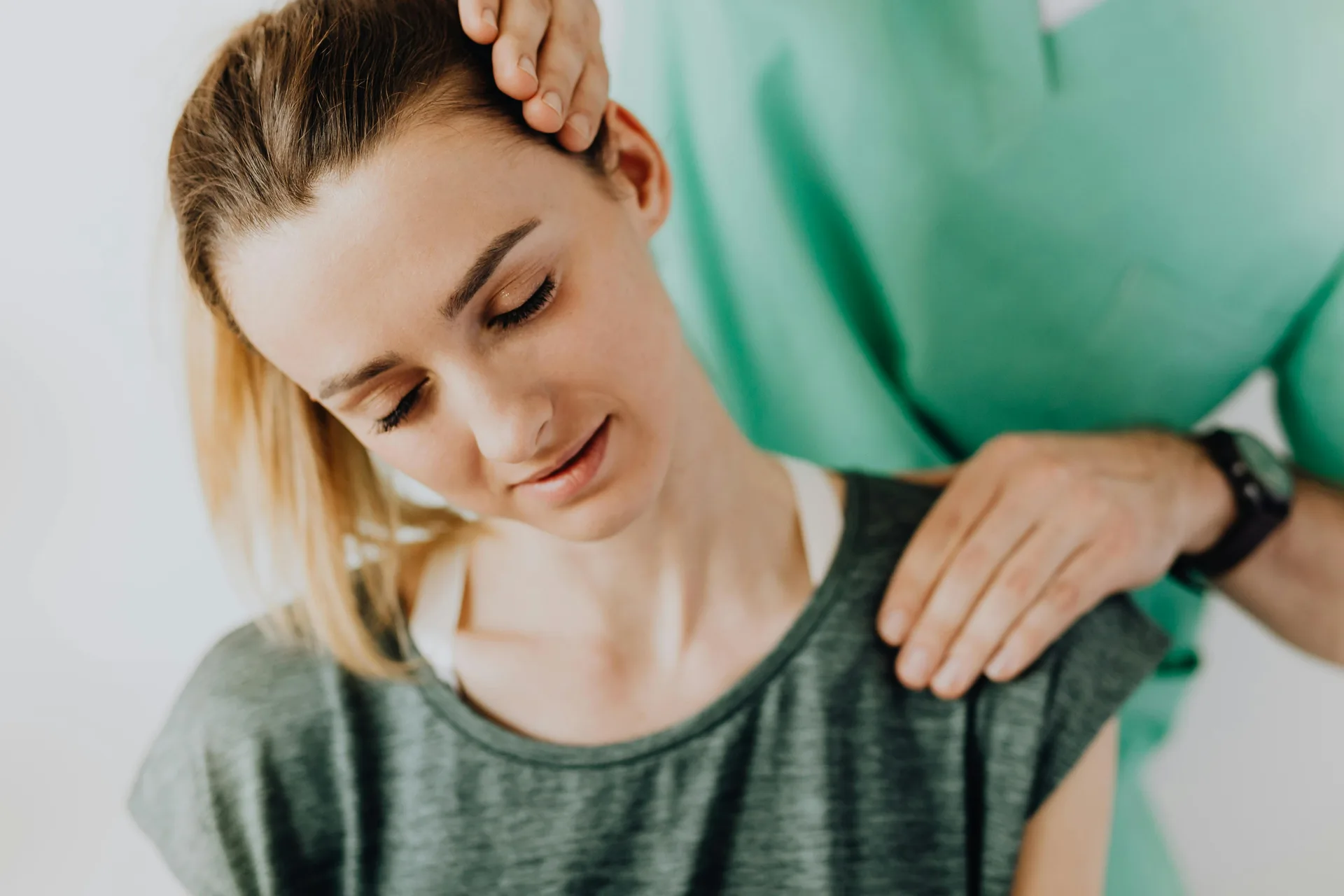 Chiropractor treating a patient's neck pain with cervical mobilisation